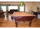Game room with pool table, hardwood floors, and seating for entertaining guests at 2521 Clipper Ship Way, Sarasota, FL 34231