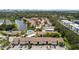 An aerial view of condos showcases community features including a pool, tennis court, and pond at 2717 Hidden Lake Blvd # C, Sarasota, FL 34237