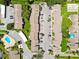 Aerial shot of condos near a swimming pool and tennis courts showcases a community-oriented neighborhood layout at 2717 Hidden Lake Blvd # C, Sarasota, FL 34237