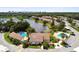 Aerial view of Lake Village office with community pools surrounded by trees and residential buildings at 2717 Hidden Lake Blvd # C, Sarasota, FL 34237