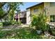 Exterior view features a screened-in patio and lush, tropical landscaping at 2717 Hidden Lake Blvd # C, Sarasota, FL 34237