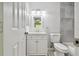 Bathroom featuring modern vanity with updated lighting, mirror, towel rack and toilet next to the shower-tub at 2717 Hidden Lake Blvd # C, Sarasota, FL 34237