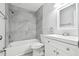 Renovated bathroom featuring a shower-tub combo with modern gray tiling and a new white vanity at 2717 Hidden Lake Blvd # C, Sarasota, FL 34237