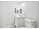 Bright bathroom with white vanity, updated lighting and a decorative mirror above a sink at 2717 Hidden Lake Blvd # C, Sarasota, FL 34237