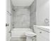 Updated bathroom featuring a shower-tub combo with modern gray tiling and white vanity at 2717 Hidden Lake Blvd # C, Sarasota, FL 34237