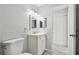 Bathroom featuring modern vanity with updated lighting, mirror, towel rack and toilet at 2717 Hidden Lake Blvd # C, Sarasota, FL 34237