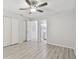 Bedroom featuring a ceiling fan with a view into a hallway and bathroom and a large closet at 2717 Hidden Lake Blvd # C, Sarasota, FL 34237