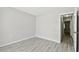 Bright bedroom featuring laminate flooring, neutral walls, and doorway to the hall at 2717 Hidden Lake Blvd # C, Sarasota, FL 34237