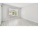 Bright bedroom featuring laminate flooring and large window for natural light at 2717 Hidden Lake Blvd # C, Sarasota, FL 34237