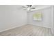 Bedroom with a ceiling fan, window, bright walls, and gray wood-look flooring at 2717 Hidden Lake Blvd # C, Sarasota, FL 34237