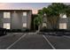 Condo exterior featuring stairs to the units, parking, and green landscaping with a mature tree at 2717 Hidden Lake Blvd # C, Sarasota, FL 34237