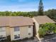 Exterior view of building with well maintained landscaping, and a new roof at 2717 Hidden Lake Blvd # C, Sarasota, FL 34237