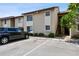Condo exterior featuring stairs to the units, parking, and green landscaping with a mature tree at 2717 Hidden Lake Blvd # C, Sarasota, FL 34237