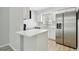 A well-lit kitchen with white cabinets, stainless steel appliances, and a kitchen island at 2717 Hidden Lake Blvd # C, Sarasota, FL 34237