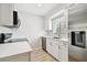 Modern kitchen featuring stainless steel appliances and updated white cabinetry at 2717 Hidden Lake Blvd # C, Sarasota, FL 34237