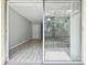 Living area featuring wood-look floors and a sliding glass door that leads to the outside at 2717 Hidden Lake Blvd # C, Sarasota, FL 34237