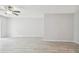 Open-concept living area featuring light gray walls, a ceiling fan, and wood-look flooring at 2717 Hidden Lake Blvd # C, Sarasota, FL 34237