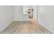 Open-concept living space with white walls and wood-look flooring that flows into the kitchen area at 2717 Hidden Lake Blvd # C, Sarasota, FL 34237