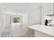 Bright living room features new floors, a ceiling fan, and a sliding glass door to the balcony at 2717 Hidden Lake Blvd # C, Sarasota, FL 34237