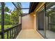 Screened patio with a view of trees and siding glass door at 2717 Hidden Lake Blvd # C, Sarasota, FL 34237