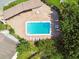 Aerial view of a community pool surrounded by a covered area and trees with plenty of lounge chairs at 2717 Hidden Lake Blvd # C, Sarasota, FL 34237