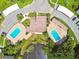 Overhead shot of community pools, carports, pond, and landscaping in a well-maintained neighborhood at 2717 Hidden Lake Blvd # C, Sarasota, FL 34237