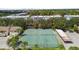 Aerial view of tennis courts, a perfect recreation amenity, surrounded by lush trees and condo buildings at 2717 Hidden Lake Blvd # C, Sarasota, FL 34237