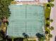 Aerial shot of tennis courts surrounded by trees and residential buildings offers an active community lifestyle at 2717 Hidden Lake Blvd # C, Sarasota, FL 34237
