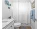 Bright bathroom featuring a white shower curtain, toilet, and decorative wall art at 3146 Heron Shores Dr, Venice, FL 34293