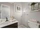 Charming bathroom featuring a vanity, framed art, floating shelves and tile floors at 380 Base E Ave # 202, Venice, FL 34285