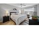 Well-lit bedroom featuring tile floors, a ceiling fan, and elegant decor and furnishings at 380 Base E Ave # 202, Venice, FL 34285