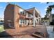 Two-story brick exterior with white trim, staircase and red brick entryway and courtyard at 380 Base E Ave # 202, Venice, FL 34285