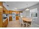 Charming kitchen with wood cabinets, white appliances, bright lighting and tiled flooring at 380 Base E Ave # 202, Venice, FL 34285