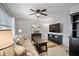 Cozy living room with neutral walls, window and a dark entertainment center with ample storage at 380 Base E Ave # 202, Venice, FL 34285