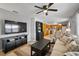 Open-concept living room leads into the kitchen and features a ceiling fan and tile flooring at 380 Base E Ave # 202, Venice, FL 34285