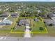 Aerial view of a home with a large, well-maintained yard surrounded by trees in a residential neighborhood at 3816 N Cranberry Blvd, North Port, FL 34286