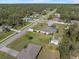 Aerial view of a home in a serene residential area, surrounded by trees and neighboring houses at 3816 N Cranberry Blvd, North Port, FL 34286