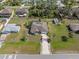 Aerial view of a well-kept home with a long driveway and spacious front and back yards at 3816 N Cranberry Blvd, North Port, FL 34286