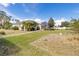 A beautiful backyard featuring mature landscaping and stone pavers leading to an enclosed lanai at 3816 N Cranberry Blvd, North Port, FL 34286