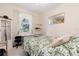 Light bedroom features a double bed, large sunny window, and neutral decor at 3816 N Cranberry Blvd, North Port, FL 34286