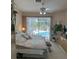 Well-lit bedroom with plush carpet, ceiling fan, and pool view at 3816 N Cranberry Blvd, North Port, FL 34286