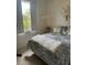 Bedroom with a comfy bed, large window, and patterned bedding at 3816 N Cranberry Blvd, North Port, FL 34286