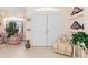 Bright foyer features double front doors, tile flooring, and decorative niches with patriotic decor at 3816 N Cranberry Blvd, North Port, FL 34286