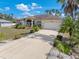 Well-maintained home featuring beautiful landscaping, a lush lawn, and an expansive driveway at 3816 N Cranberry Blvd, North Port, FL 34286