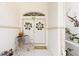 Charming covered front porch with double doors, a welcome sign and a decorative metal chair at 3816 N Cranberry Blvd, North Port, FL 34286