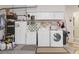 Laundry room with washer, dryer, sink, and storage cabinets, offering convenience and functionality at 3816 N Cranberry Blvd, North Port, FL 34286