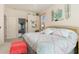 Bright main bedroom features pastel patterned bedding, mirrors, and an ensuite bathroom at 3816 N Cranberry Blvd, North Port, FL 34286