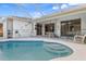 In-ground pool with spa, surrounded by a screened lanai and lush landscaping at 3816 N Cranberry Blvd, North Port, FL 34286