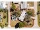 Aerial view shows property with mature trees, lush lawns, and a detached garage at 434 W Grace St, Punta Gorda, FL 33950
