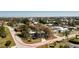 Aerial view of a cozy single-story home surrounded by lush greenery in a quiet neighborhood at 434 W Grace St, Punta Gorda, FL 33950